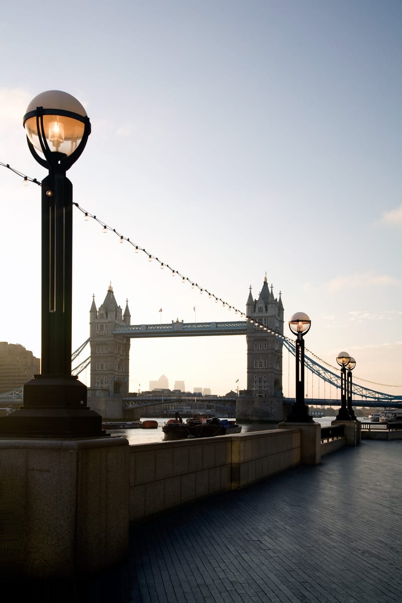 Ornate globe lamps on the riverside at sunrise, Tower Bridge behind